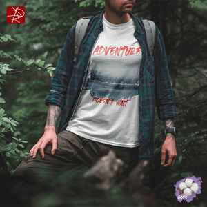 Unisex organic cotton t-shirt with 'Adventure Doesn't Wait' design over snowy lake scene, worn by a person in nature.