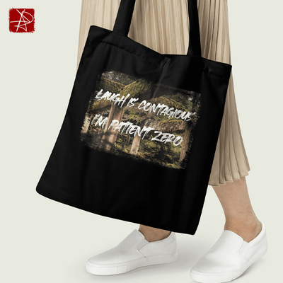 Eco-friendly black tote bag featuring forest design and 'Laugh Is Contagious - I'm Patient Zero' text.