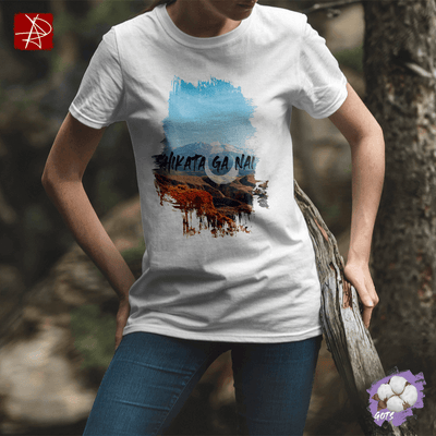 Unisex organic cotton t-shirt with 'Shikata Ga Nai' design, featuring desert colors and eco-friendly styling.